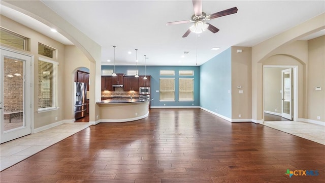322 Wauford Way, New Braunfels, TX 78132 - living room with wood-type flooring, arched walkways, ceiling fan, baseboards, and recessed lighting