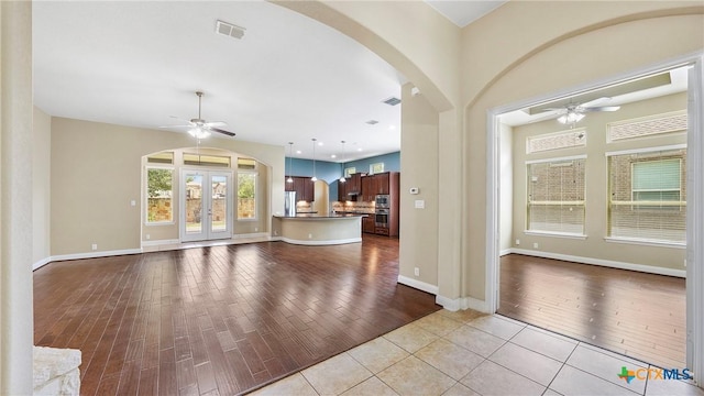 322 Wauford Way, New Braunfels, TX 78132 - unfurnished living room with a ceiling fan, arched walkways, wood finished floors, and baseboards