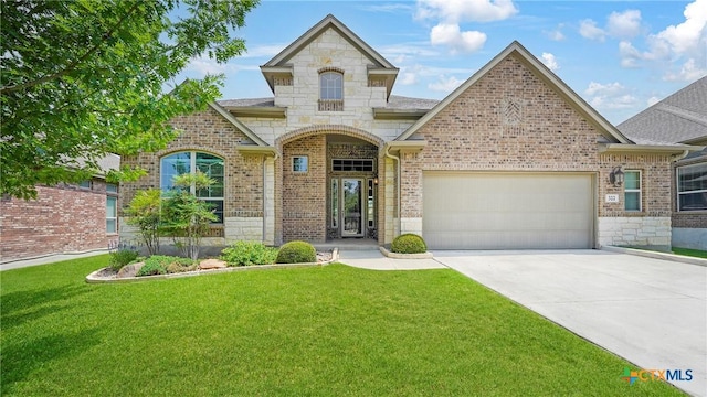 322 Wauford Way, New Braunfels, TX 78132 - french country inspired facade featuring stone siding, an attached garage, driveway, and a front lawn
