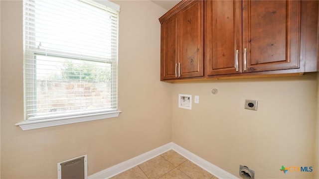 322 Wauford Way, New Braunfels, TX 78132 - laundry room with hookup for an electric dryer, hookup for a washing machine, cabinet space, baseboards, and light tile patterned flooring