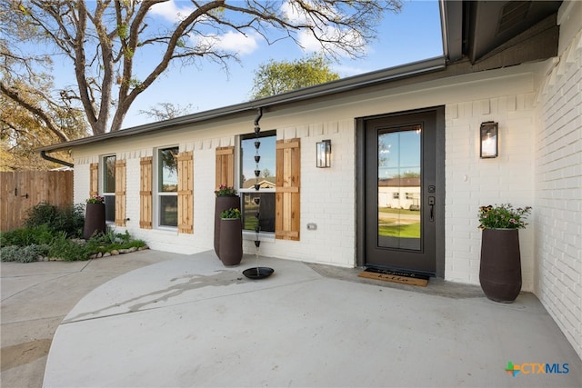 property entrance featuring a patio