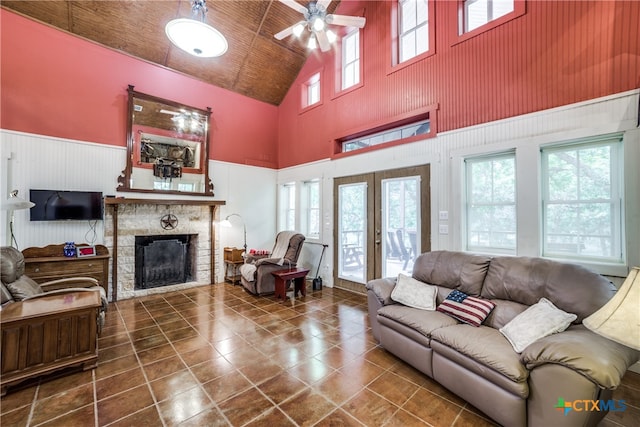 tiled living room with a wealth of natural light, french doors, and a fireplace