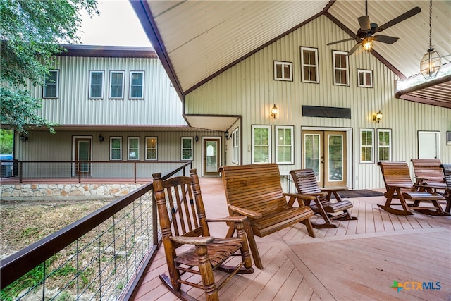 rear view of house featuring ceiling fan and a wooden deck