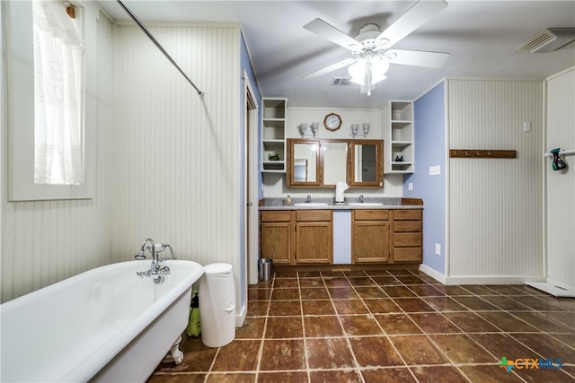 bathroom with a tub to relax in, vanity, and ceiling fan