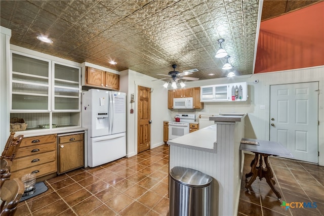 kitchen with an ornate ceiling, white appliances, light countertops, glass insert cabinets, and ceiling fan