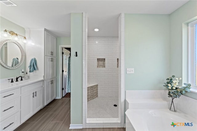 bathroom featuring vanity and independent shower and bath