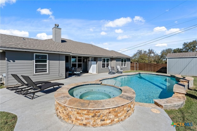 view of pool with a patio and an in ground hot tub