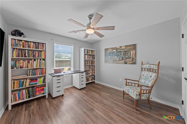 living area featuring dark hardwood / wood-style flooring and ceiling fan