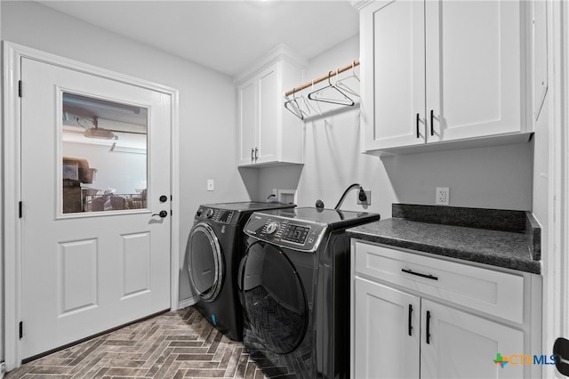 laundry room with cabinets and washer and clothes dryer