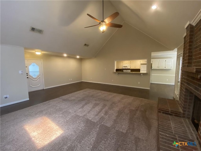 505 Sun Meadows Dr, Harker Heights, TX 76548 - unfurnished living room with a ceiling fan, dark carpet, a brick fireplace, baseboards, and high vaulted ceiling