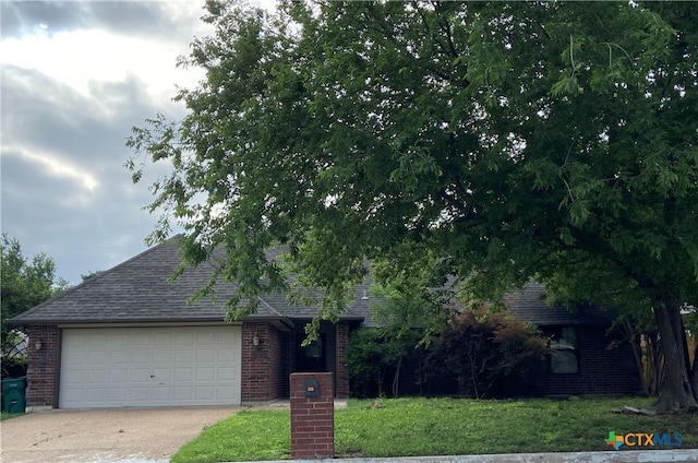 505 Sun Meadows Dr, Harker Heights, TX 76548 - obstructed view of property featuring brick siding, driveway, roof with shingles, and an attached garage