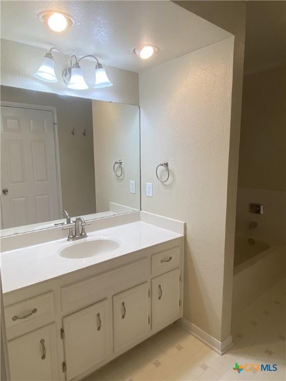 505 Sun Meadows Dr, Harker Heights, TX 76548 - bathroom featuring vanity, a bath, and baseboards