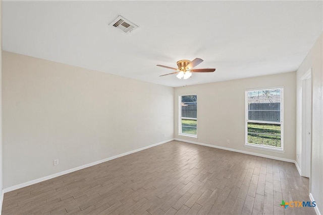 spare room featuring hardwood / wood-style flooring and ceiling fan