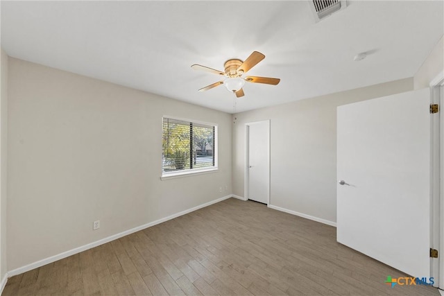 empty room with ceiling fan and hardwood / wood-style floors