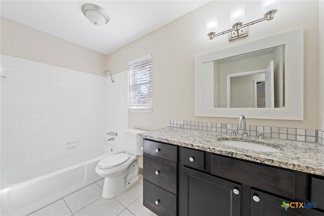 full bathroom featuring toilet, tiled shower / bath combo, tile patterned flooring, and vanity