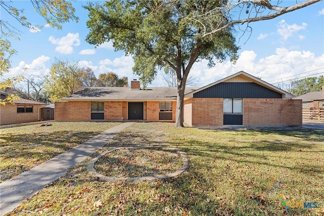 rear view of house featuring a yard