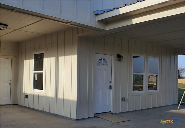 doorway to property featuring board and batten siding