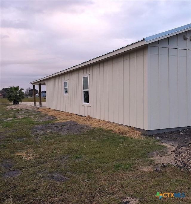 view of side of property with a yard