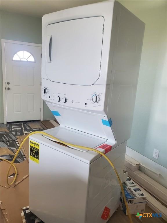 laundry room featuring stacked washer and clothes dryer