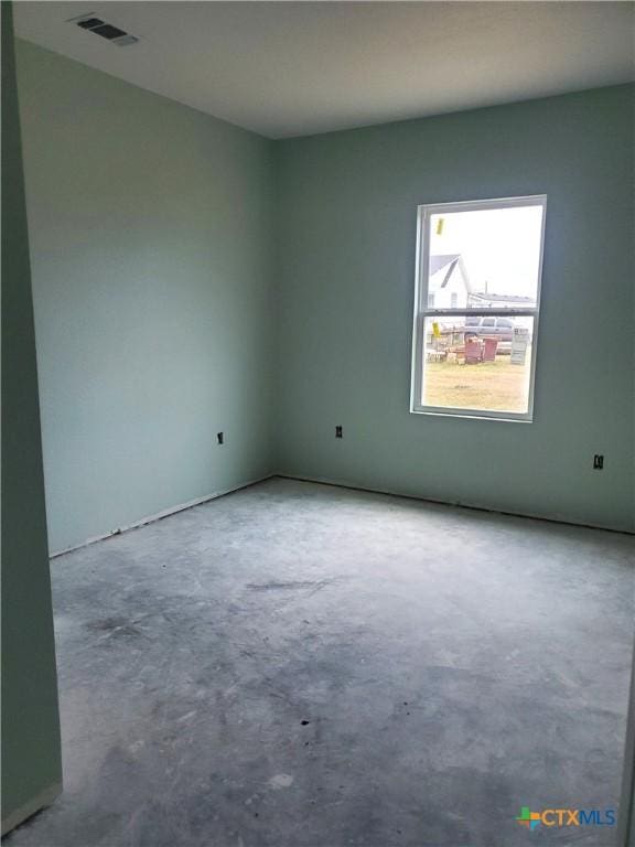 spare room featuring visible vents and unfinished concrete flooring