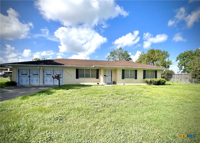 single story home with a garage and a front yard