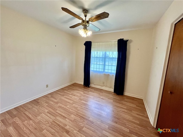 empty room with light wood-type flooring and ceiling fan