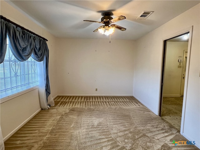 unfurnished room featuring ceiling fan and light colored carpet