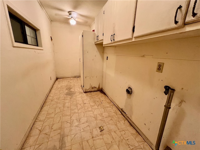 laundry room with cabinets, ceiling fan, hookup for a washing machine, and crown molding