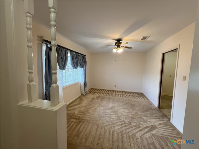 carpeted empty room with ceiling fan