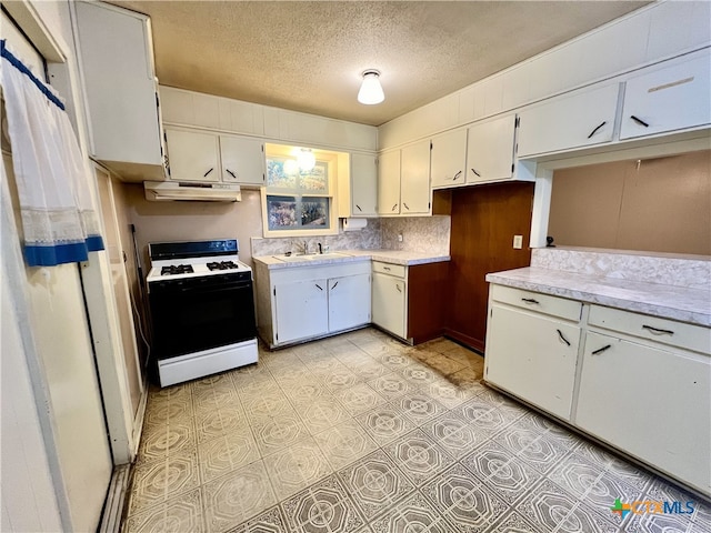 kitchen with white cabinetry, a textured ceiling, white range, decorative backsplash, and sink