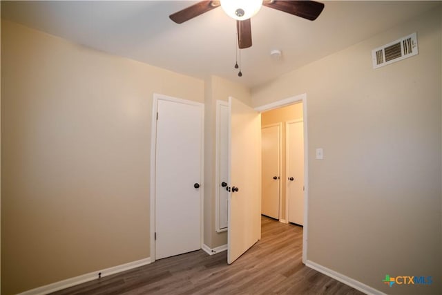 unfurnished bedroom featuring ceiling fan and hardwood / wood-style flooring