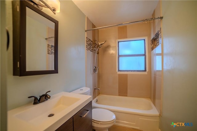 full bathroom featuring toilet, tiled shower / bath combo, and vanity