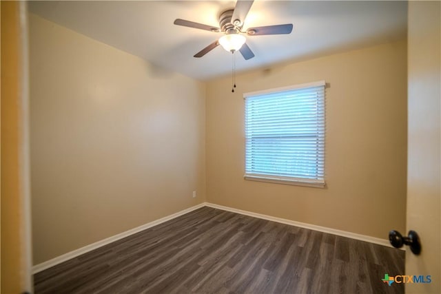 spare room featuring ceiling fan and dark wood-type flooring