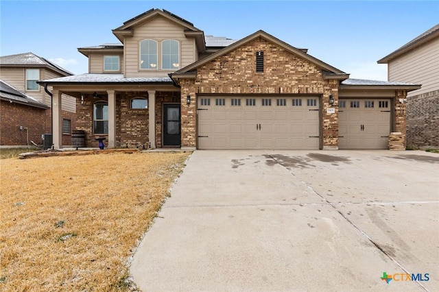 view of front of house with a garage, a porch, concrete driveway, and brick siding