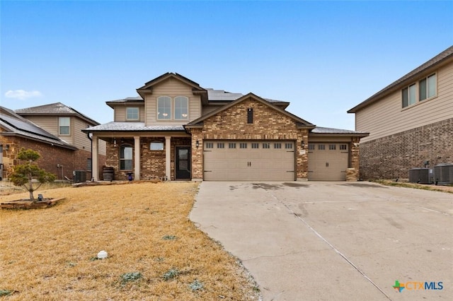 view of front of property with brick siding, a porch, a garage, cooling unit, and driveway