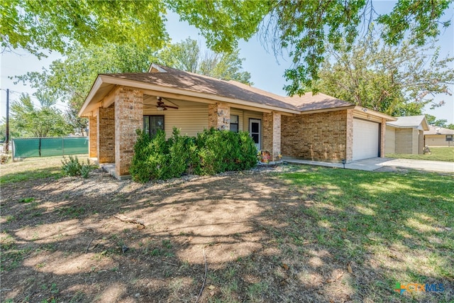 ranch-style home featuring a garage, a front yard, and ceiling fan