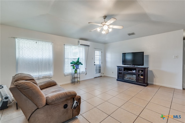 tiled living room with lofted ceiling, a wall mounted air conditioner, and ceiling fan