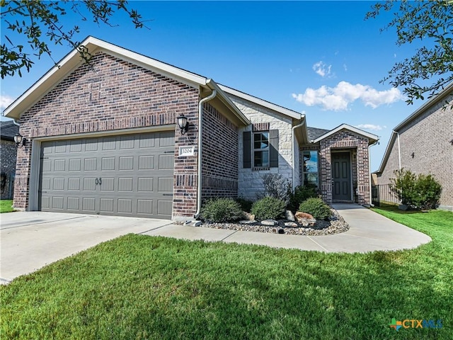 view of front of house featuring a garage and a front lawn