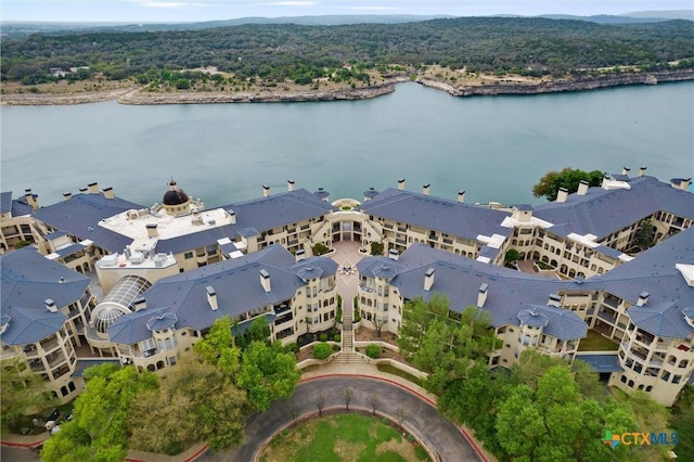 birds eye view of property featuring a wooded view and a water view