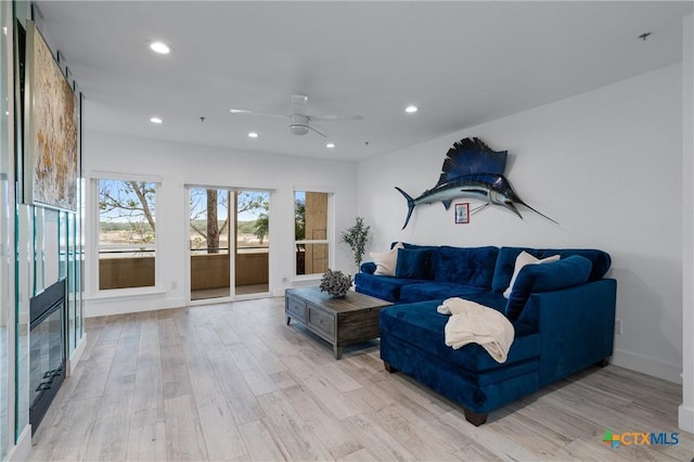 living room featuring light wood-type flooring, recessed lighting, and a ceiling fan