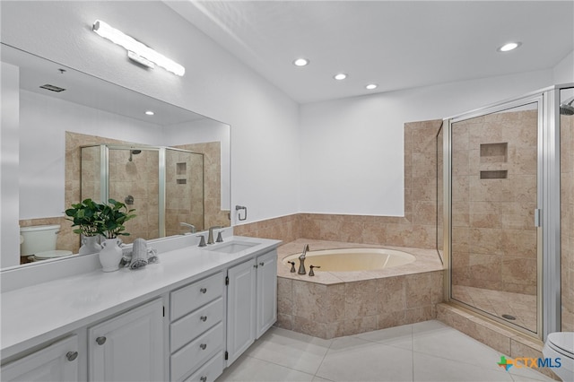 full bathroom featuring a shower stall, a garden tub, and vanity