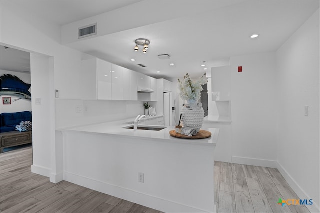 kitchen featuring light countertops, visible vents, white cabinetry, and light wood-style floors