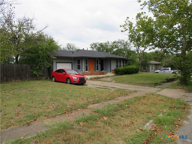 single story home featuring a garage and a front lawn