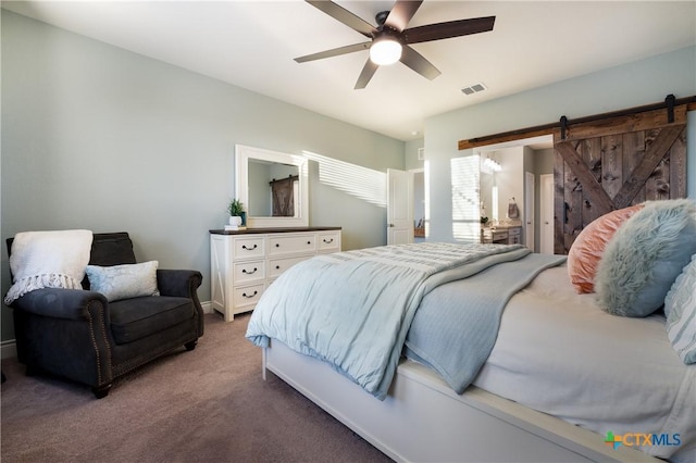 bedroom featuring carpet floors, a barn door, and ceiling fan