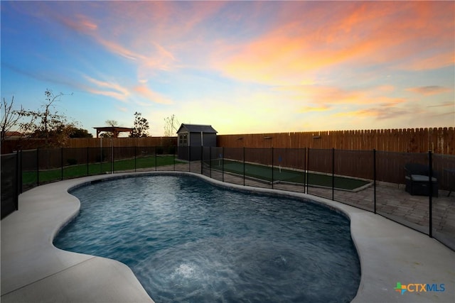 pool at dusk with a patio area