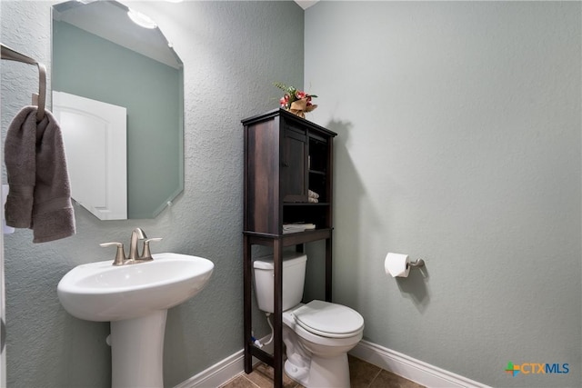 bathroom with tile patterned floors and toilet