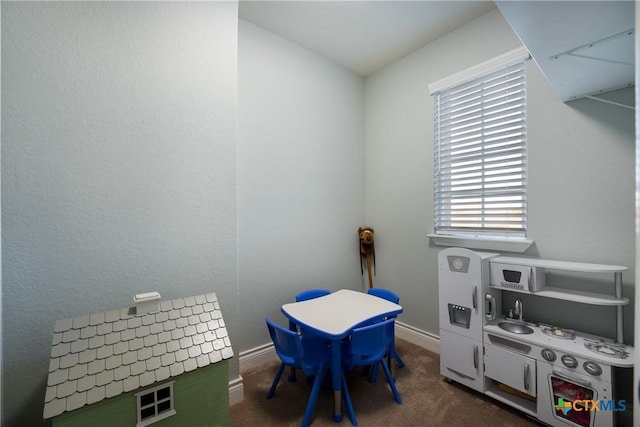 playroom with dark colored carpet