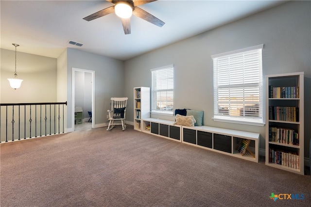 interior space featuring ceiling fan and carpet floors