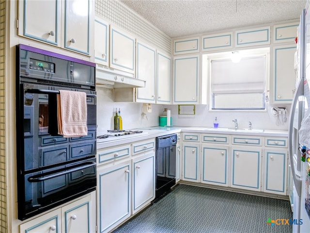 kitchen featuring a textured ceiling, sink, black appliances, and white cabinetry