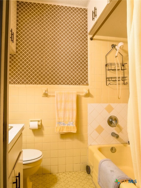 full bathroom with vanity, tile patterned floors, and tile walls